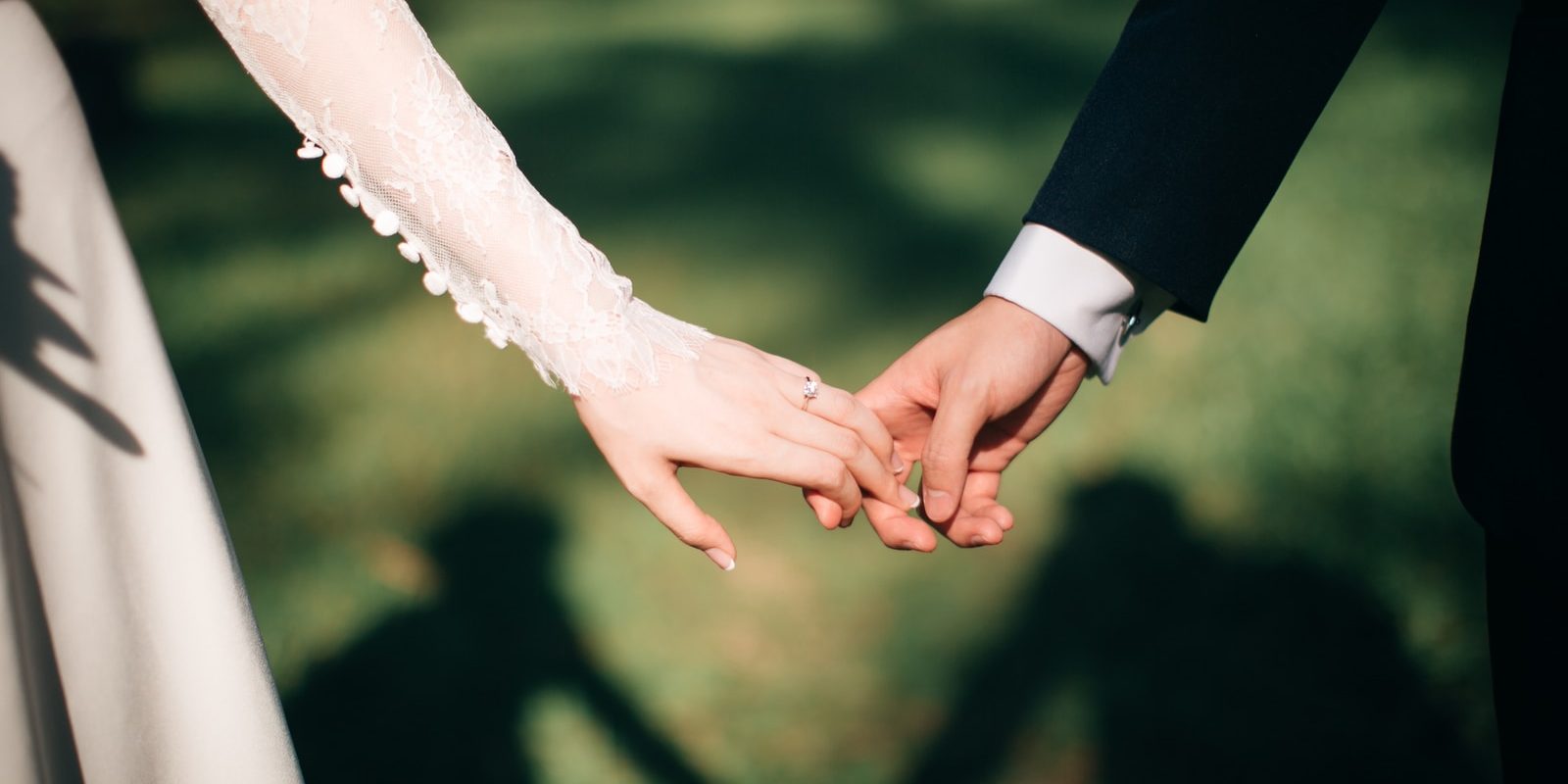 man and woman holding hands focus photo