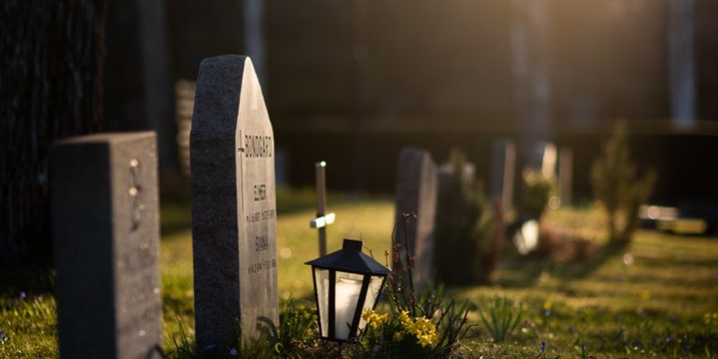 white cross on green grass during daytime